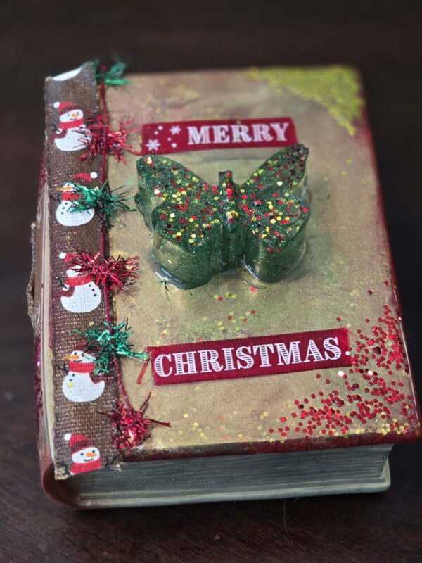 Whimsical Christmas-Themed Book-Shaped Trinket Box with Sparkly Butterfly Handle and Snowmen